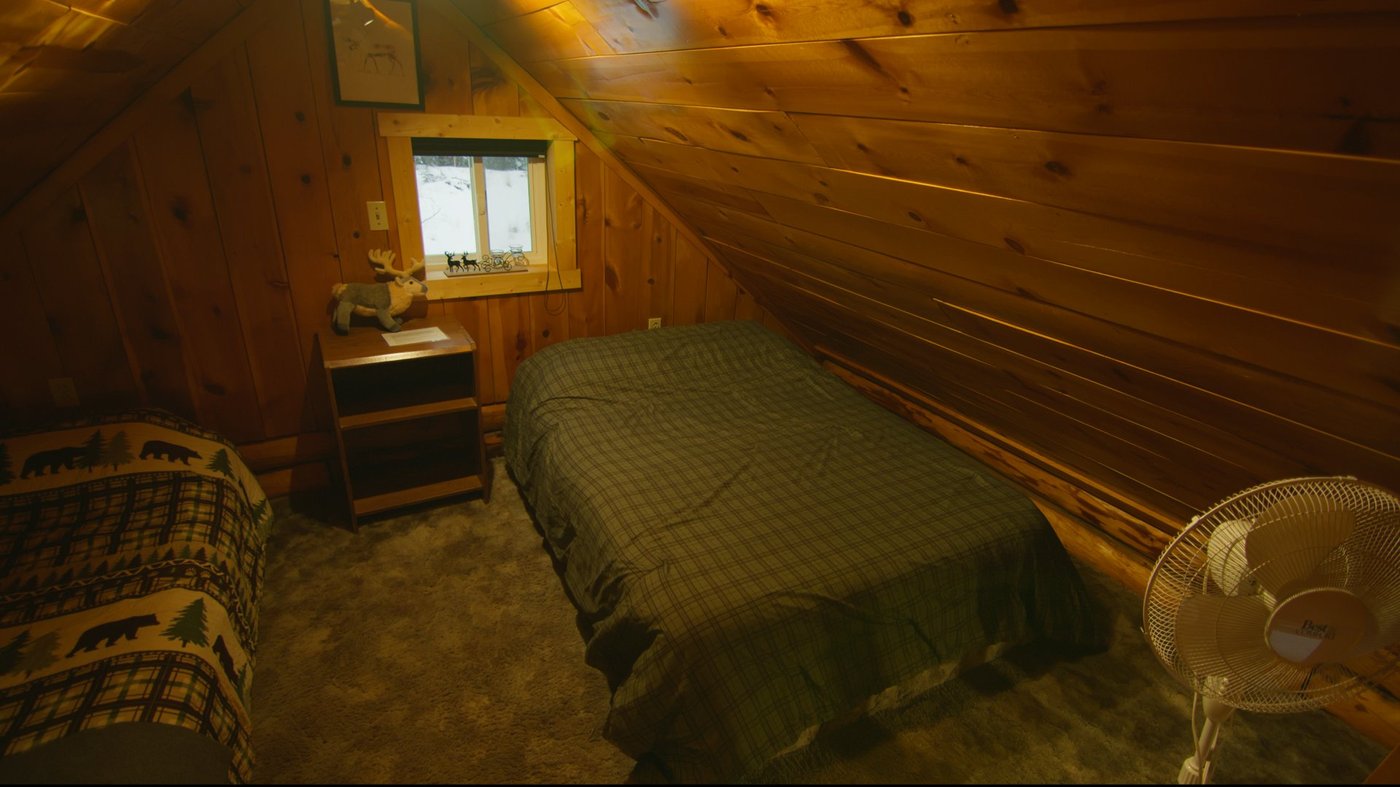Loft bedroom with plaid quilt