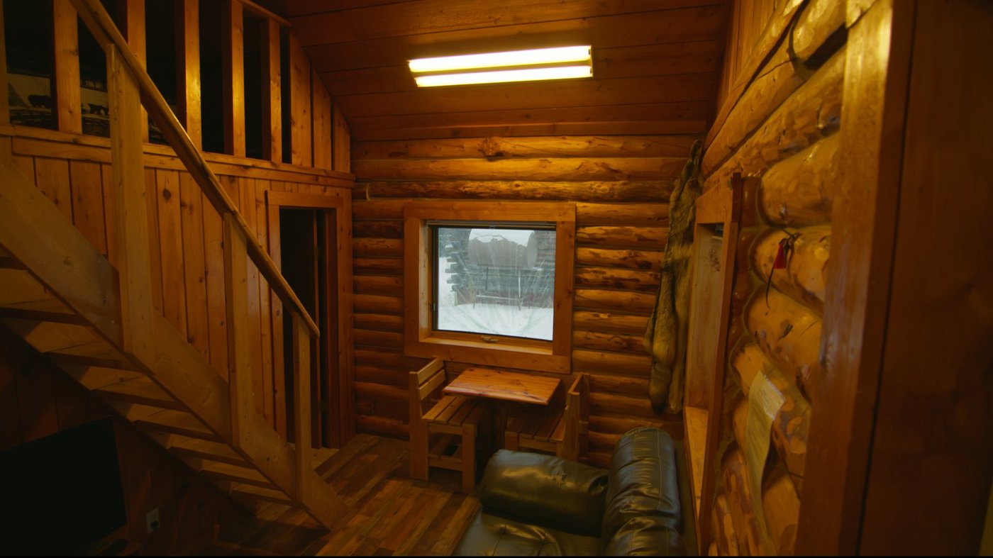 Cabin lounge with leather couch and window